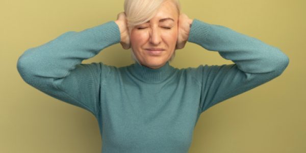 unpleased-pretty-blonde-slavic-woman-closes-ears-with-hands-olive-green (2)